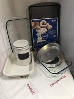 Photo showing clear Pyrex glass dishes, storage canister, Wilton cake pans, vintage white dish, and Pillsbury cookie sheet