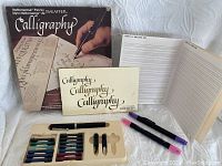 Sheaffer calligraphy pen set with box, booklets, pen, two nibs, ink cartridges, and practice guides.