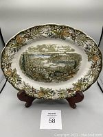 Front view of vintage Ridgway Heritage serving plate on a stand showing detailed scenic design and decorative border.
