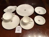 Full 8-piece set of Wedgwood bone china on wooden table
