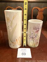 Photo showing two ceramic vases side by side with a tape measure indicating height and a MaxSold lot card.