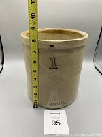 Side view showing height next to measuring tape approx 9.5 inches tall with '1 IMPERIAL' printed on the side along with 'MEDALTA MEDICINE HAT ALTA' stamp near the base.