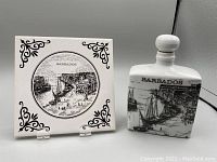 Photo showing Barbados ceramic tile and bottle with detailed black and white illustrations.