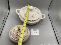 Schuman Wild Rose covered bowl with floral pattern and repaired lid handle, measured with tape showing approximately 12 inches width.