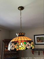 Full view of the stained glass ceiling light hanging from chain on ceiling