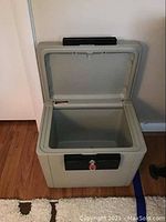 Sentry safe model 1170 open, showing empty insulated interior.