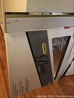 Original packaging box of Stanley Basics vanity mirror with some box wear visible.