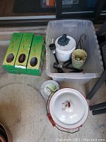 Full lot showcasing all items including enamel pot, plastic bucket, solar lights in boxes, and plant watering devices.