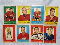 Photo showing 8 vintage Topps NHL hockey cards featuring players Marcel Pronovost, Red Kelly, Glenn Hall, Earl Balfour, Charley Burns, Gordie Howe, Fern Flaman, Camille Henry.