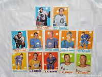 Photo showing 13 vintage NHL hockey cards from the 1960s featuring various players from Flyers, Penguins, Sabres, Maple Leafs, Kings, and Rangers.