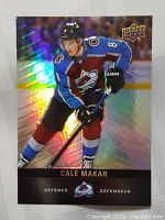 Front of the 2019 Upper Deck Cale Makar rookie card showing holographic image of player in Avalanche uniform.