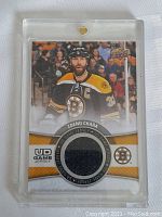 Front of hockey card showing Zdeno Chara in Bruins jersey with circular game-used jersey fabric piece.