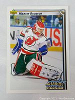 Front of the 1992 Upper Deck Martin Brodeur rookie card showing image of Brodeur in goalie stance with New Jersey Devils colors and Star Rookies logo.