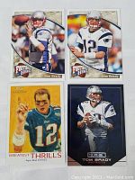 Five Tom Brady football trading cards laid out, including Football Heroes series, Topps Greatest Thrills, and a card with dark blue background.