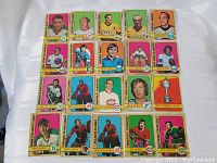 Photo showing an array of 18 1972 O-Pee-Chee NHL hockey cards laid out flat on a white surface with several players and the Hart Memorial Trophy card visible.