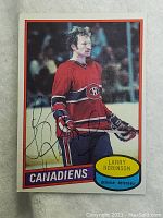 Front of vintage Larry Robinson Canadiens hockey card with autograph in ink visible.