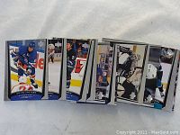 Close-up view of various 1998-99 Upper Deck hockey cards featuring different players in game action.