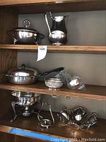 Three-tier wooden shelf displaying all pieces.