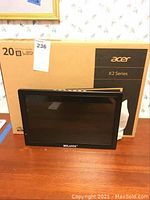 Front view of 14 inch Milanix monitor in front of Acer K2 Series box for 20 inch monitor