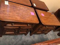 Pair of wooden Drexel nightstands showing the top and front with detail of drawers and cabinet doors.