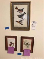 Photo of one framed print with three birds in flight and two smaller framed watercolor paintings of birds on branches, with notes and lot number visible