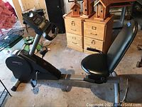 Side view of ProForm SR-30 recumbent exercise bike showing padded seat with backrest, pedals, and part of console.