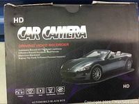 Closed box of HD car camera driving video recorder showing product branding and features.