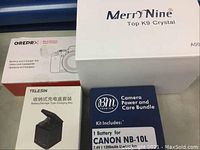 Photo showing MerrDnine Top K9 Crystal box and packaging for camera batteries and charger sets