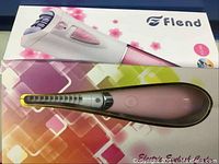 Flend epilator and electric eyelash curler on top of their boxes