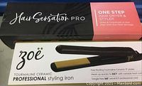 Box of Hair Sensation Pro One Step Hair Dryer and Styler and box of Zoe Tourmaline Ceramic Professional Styling Iron with visible products.