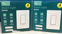 Two unopened boxes each labeled Treatlife Smart Light Switch 4-Pack, highlighting voice control, group control, remote access, and light scheduling features.