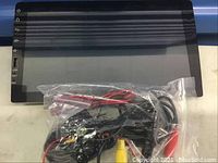 Car dash screen with visible touch-sensitive icons on the left side, screen in open box condition.