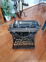 Front view of black Underwood Standard typewriter with round cream keys and visible Underwood logo on carriage.
