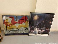 Two framed prints side by side: Picasso linoleum cut print and Ken Keely street scene print.