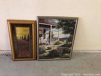 Photo showing both framed landscape art prints side by side on the floor, one taller and narrow, the other wider and almost square.