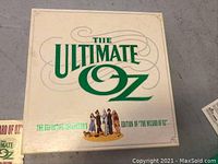 Top view of white box with green text and characters from The Wizard of Oz, labeled 'The Ultimate Oz' collector's edition.