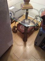 Clear beveled and scalloped glass top with wrought iron and wood base supports.