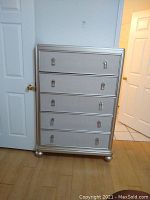 Full view of silver five-drawer chest showing the overall design and hardware.