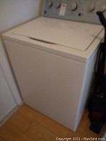 Front angle view of the white Kenmore Series 500 washing machine, showing top lid and front panel.