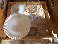 Set of serving dishes in wooden drawer: milk glass pieces, punch bowl, and cut glass appetizer dishes.