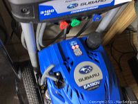 Top view of Subaru EA190 engine cover with logo and mounted color-coded nozzles.