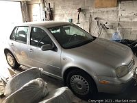 Front three-quarter view showing silver paint, front bumper, headlights