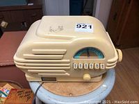 Side view of beige retro Thomas Collectors Edition radio and cassette player, showing overall shape and buttons.