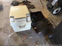 Pak-A-Potti chemical toilet next to portable grill and oil burner.