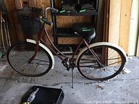 Full side view of the vintage ladies bicycle, showing the frame, tires, saddle, and handlebar.