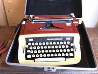 Front angled view of Royale Custom 3E typewriter in carrying case showing keyboard and partial body.
