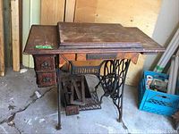 Overall view of oak cabinet and cast iron treadle base