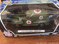 Photo of the 1940 Ford Sedan Ambulance diecast model in original box showing front and side view through clear plastic.