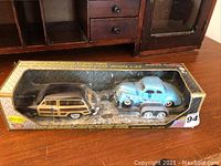 Full box display showing 1949 Ford Woody Wagon with trailer carrying 1940 Ford Coupe in original packaging