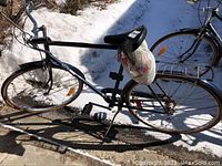 Full side view of the bicycle showing frame, seat, tires, and overall condition.